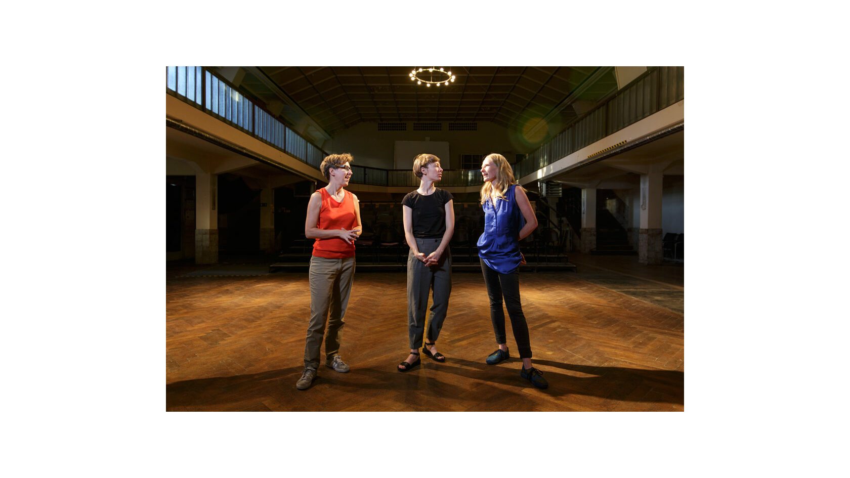 Gruppenfoto der Initiatorinnen des Projekts Polylog Dresden, Barbara Lubich, Anna Till sowie Bettina Lehmann, im Ballsaal des Pieschener Zentralwerks.