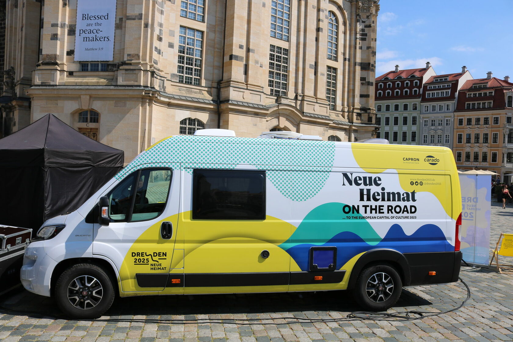 The "Neue Heimat on the road" motor home is parked on the Neumarkt in front of Dresden's Frauenkirche.