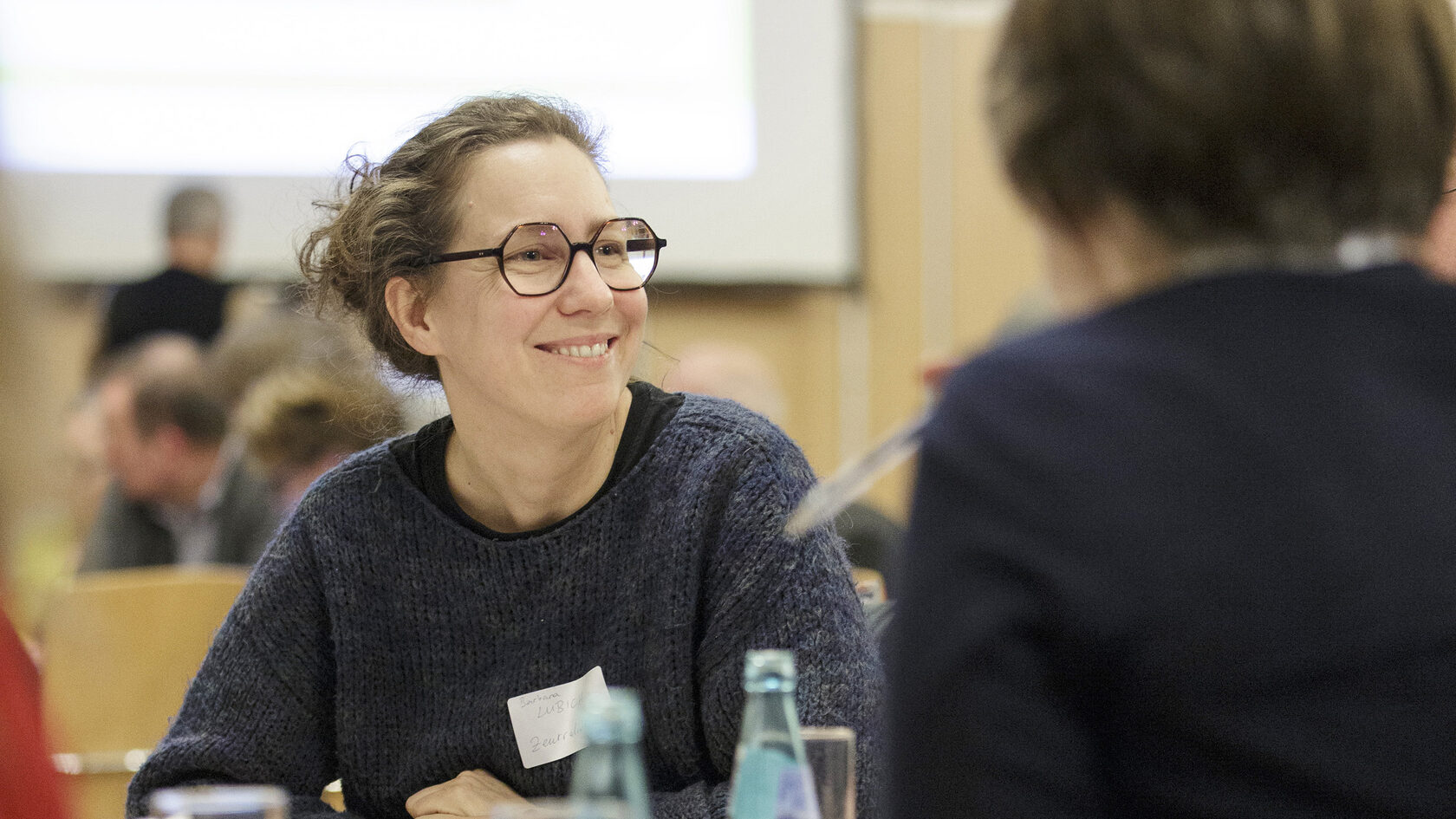 A participant is seen sitting at a table at the kick-off event for the platform process.